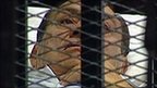 Hosni Mubarak is pictured on state TV in a cage in court at the Police Academy in Cairo, Egypt, as he faces his first day on trial